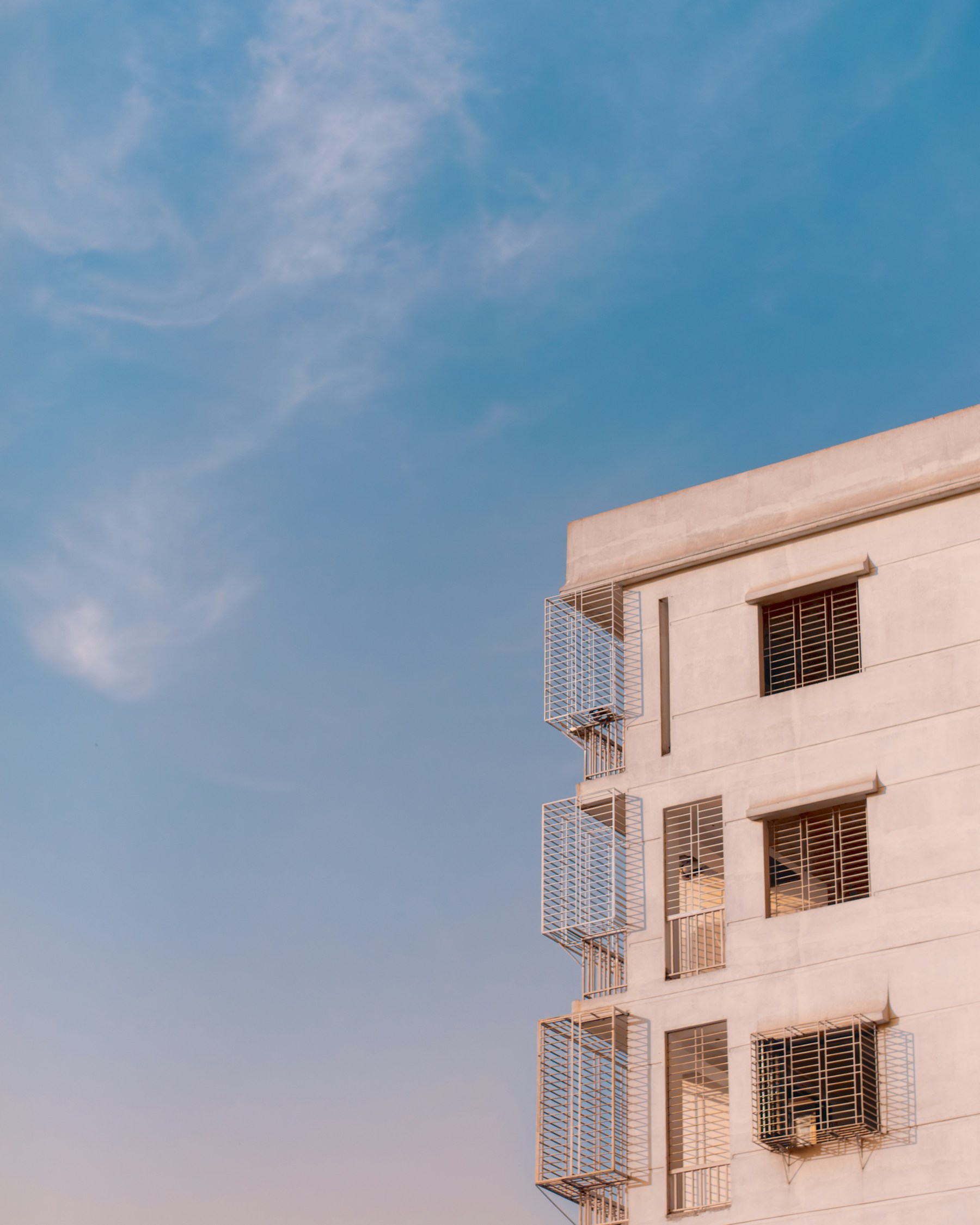 Modern apartment building photographed against a blue sky